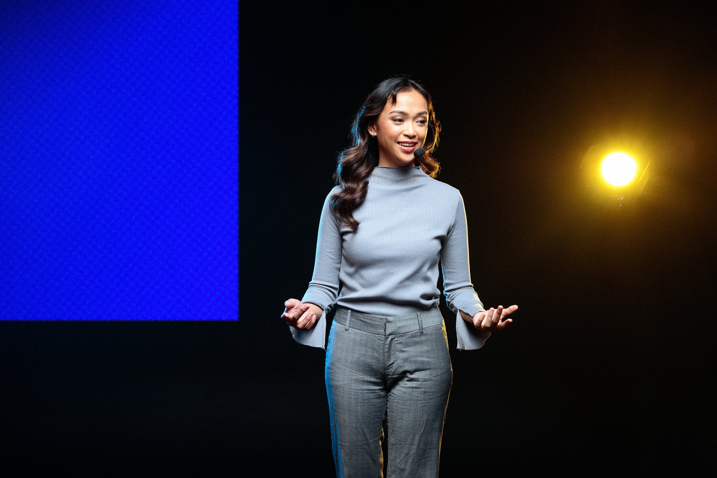 Woman Giving a Talk in Public on Stage