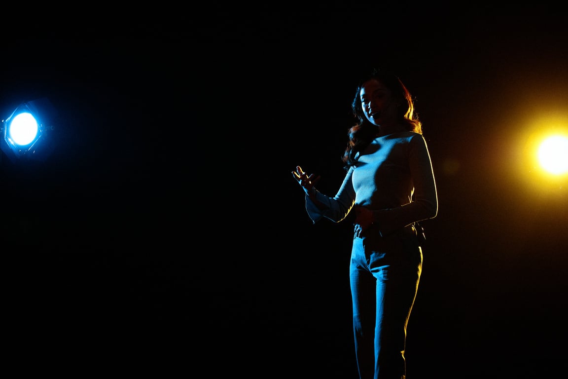 Woman Giving a Talk in Public on Stage