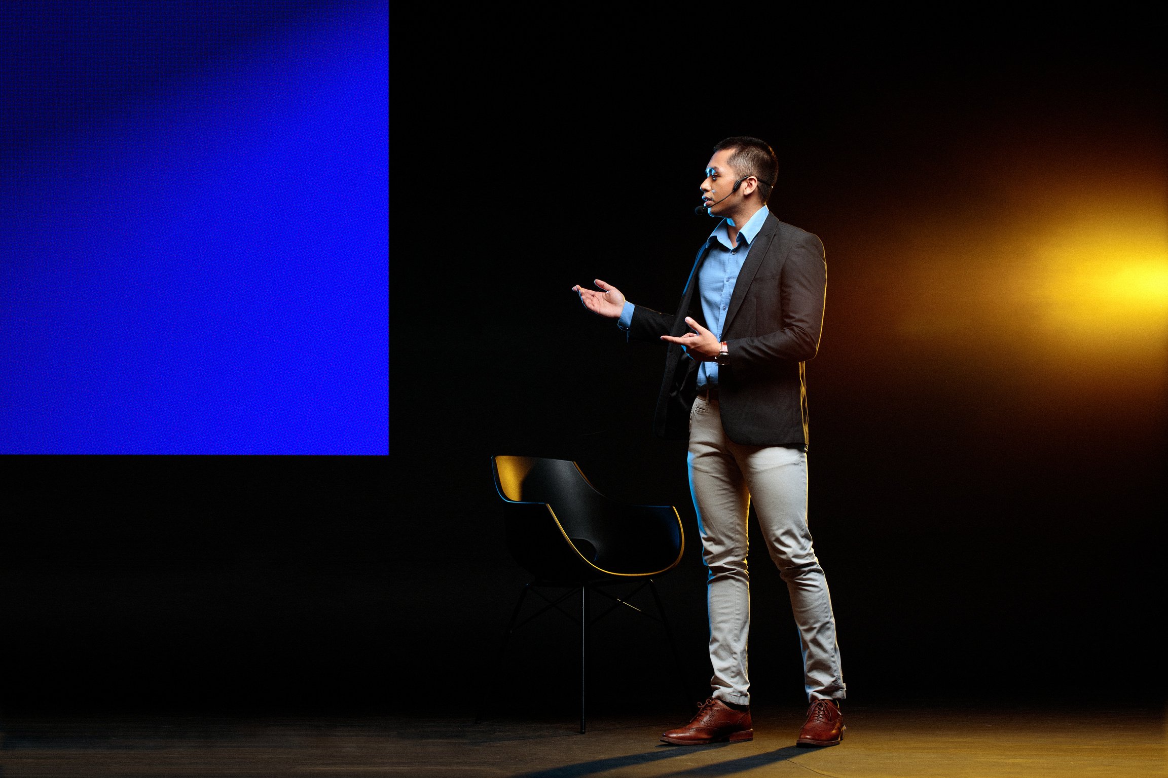 Man Giving a Talk in Public on Stage